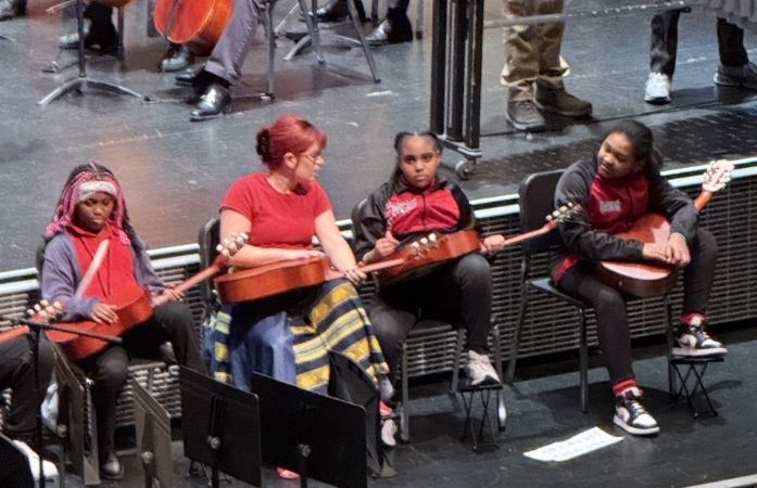  Dr. K . music teacher with 3 scholars on stage